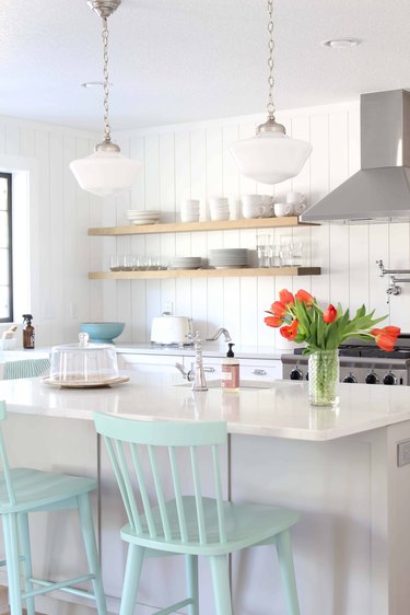 white and sea green farmhouse kitchen with milk glass pendants