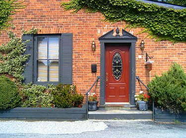 Brick house with gray trim and red door