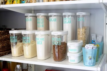 Pantry shelf with labeled containers.