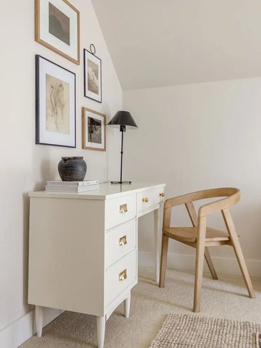 neutral home office with white desk and small gallery wall