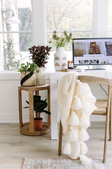 neutral home office with wood office chair and side table