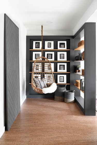 rattan hanging chair in gray basement space