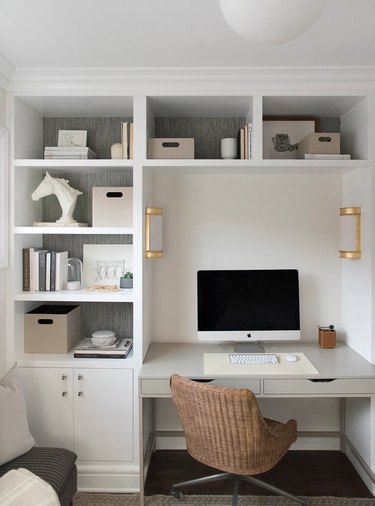 neutral home office with white built-ins and brass wall sconces