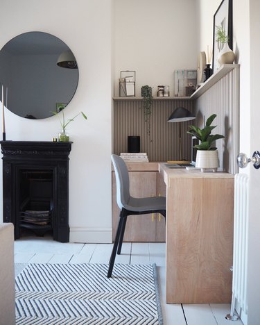 neutral home office with modern accent wall and wood desk