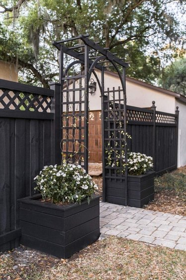 coastal grandmother decor idea for patio with arbor and white floral arrangements