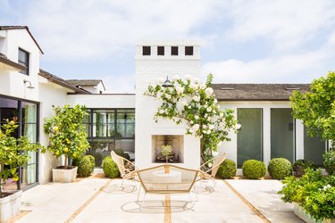 coastal grandmother decor idea for patio framed by potted plants