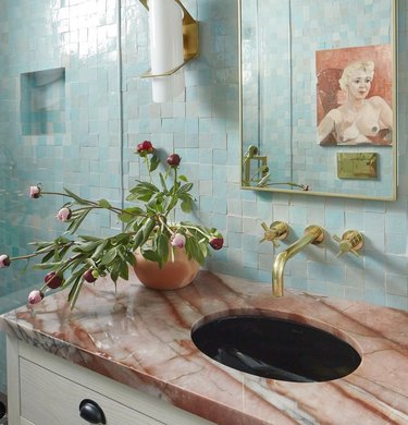 Bathroom with powder blue tile walls and rust countertop