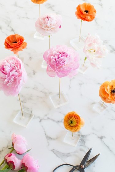 pink and orange summer flower arrangement showcased on a marble table