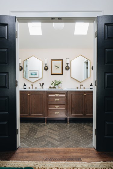 bathroom with pair of overhead skylights and sconces
