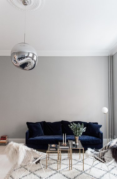 gray living room with navy blue velvet sofa