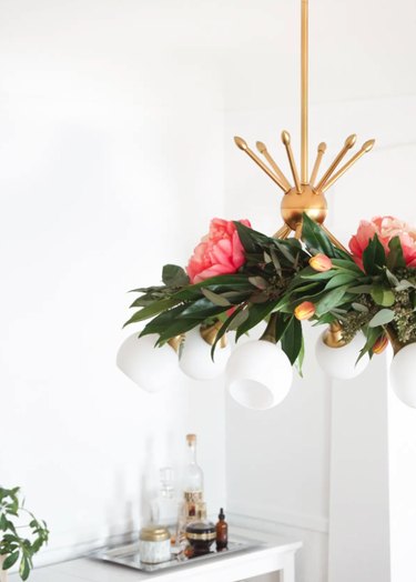 summer flower arrangement idea with garland draped around chandelier
