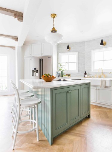 green kitchen island with white cabinets
