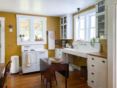 yellow walls with white cabinets