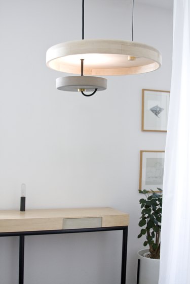 Disk pendant light in white room