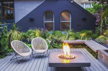 Deck with firepit, built-in benches, chairs.