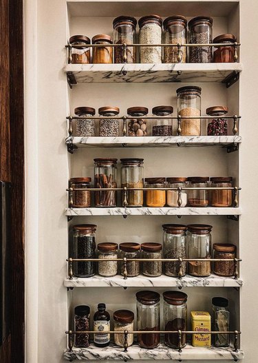 Spice rack on marble shelves.