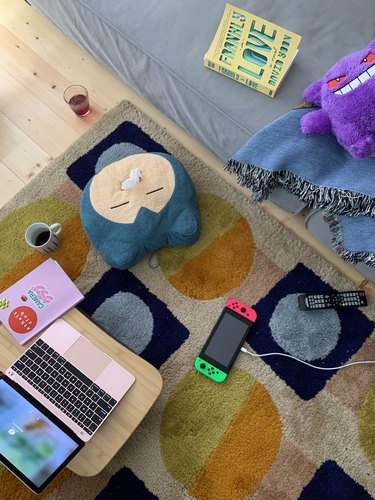 overhead view of rug with laptop and pillows