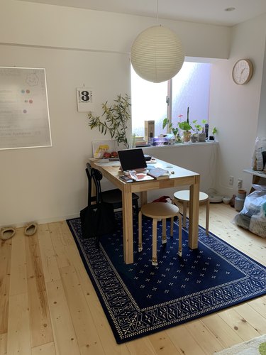 dining room area with blue rug and white lighting fixture