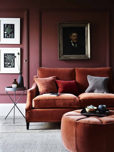 living room with rust furniture and burgundy walls