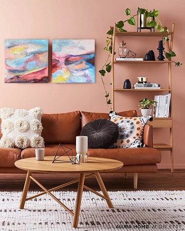 Living room with pink wall and brown leather sofa