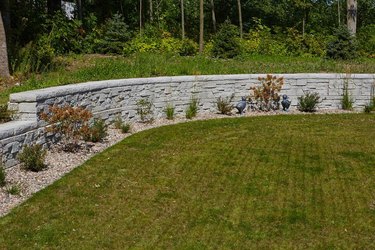 A mechanically stabilized earth retaining wall in a large backyard
