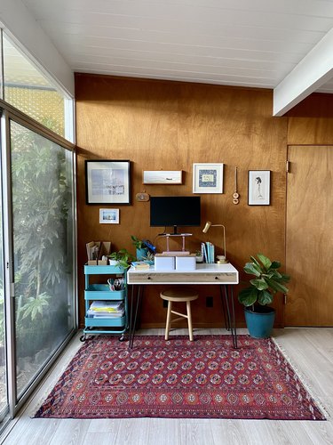 Mae Respicio's writing nook against wood wall