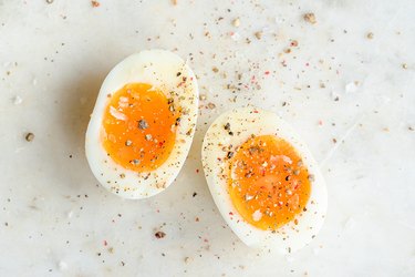Hard-boiled eggs with spices on a white background