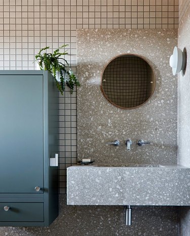 bathroom with terrazzo sink and square tiles