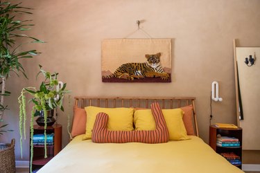 guest bedroom with Roman clay wall treatment and yellow bedding