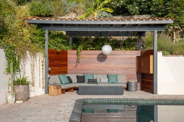 exterior patio with seating overlooking pool with dark tile