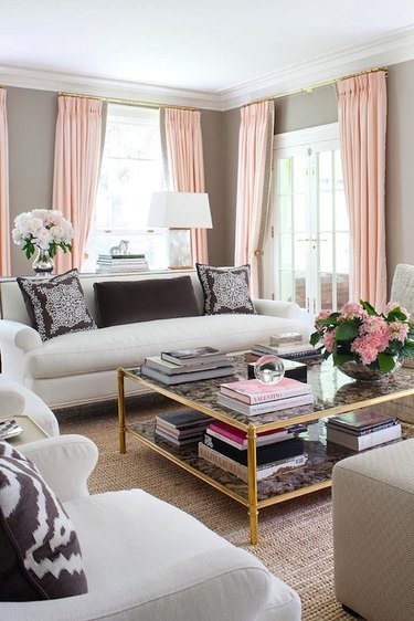 Classic living room with gray walls and pink curtains.