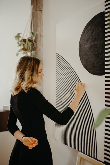 Sofia Shu painting canvas in art studio