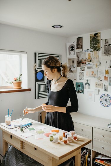 Sofia Shu painting in art studio