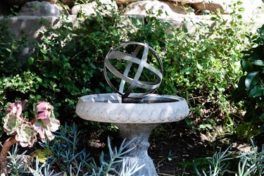 Small decorative garden fountain with bushes