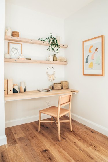 corner home office with wood shelves and leather office chair