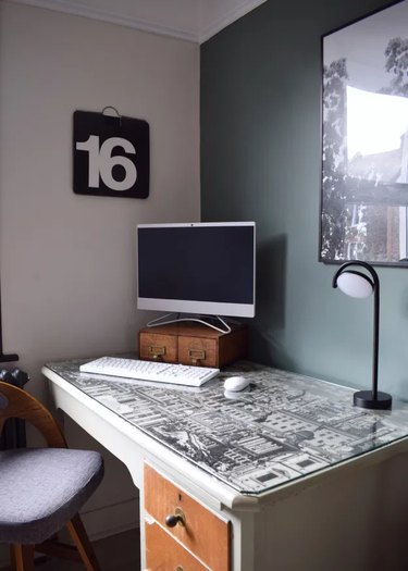 corner home office with green accent wall and minimalist decor