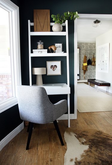 corner home office with desk that includes vertical shelving