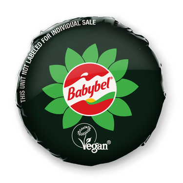 The green wax casing surrounding Babybel's plant-based white cheddar cheese.