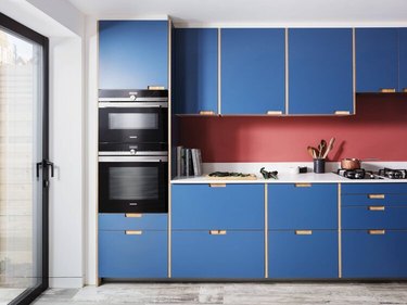 blue and red kitchen color idea with black appliances