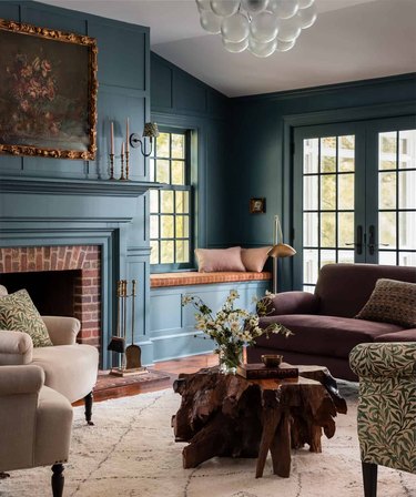 teal living room with brown sofa and coffee table