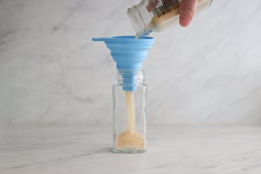 Transferring garlic powder from store-bought jar into glass jar