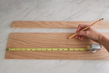 Marking width of drawer on wood with tape measure