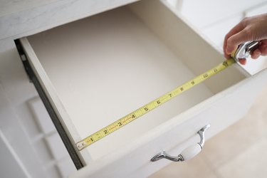 Measuring width of drawer with tape measure