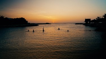 swimmers at sunset in Curacao