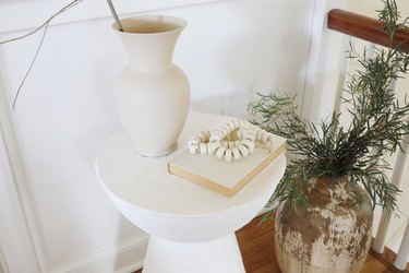 DIY plaster side table styled with vase and book