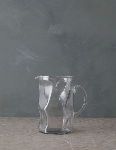 A glass pitcher with a wavy shape