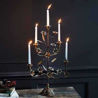 brass floral candelabra with lit candles