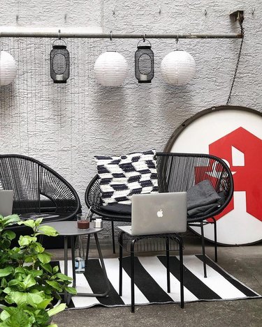 outdoor office with black chair and throw pillows