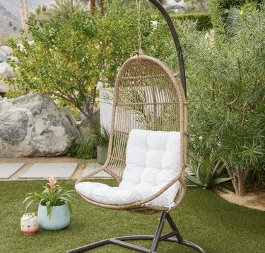 Hanging papasan in garden surrounded by trees