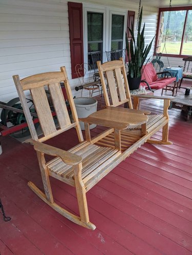 Two light wood rocking chairs connected by a table
